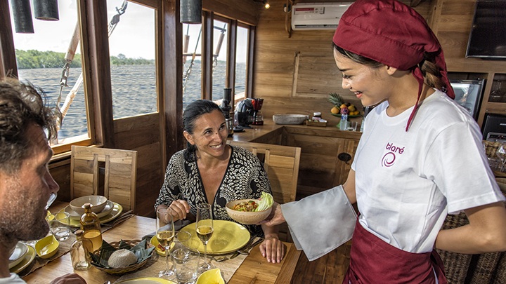 The liveaboard crew is serving the guests