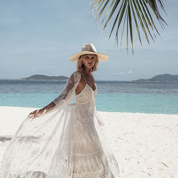 A woman wearing a white dress in the beach