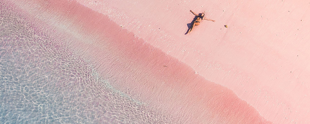 Laying in the sand of Pink beach